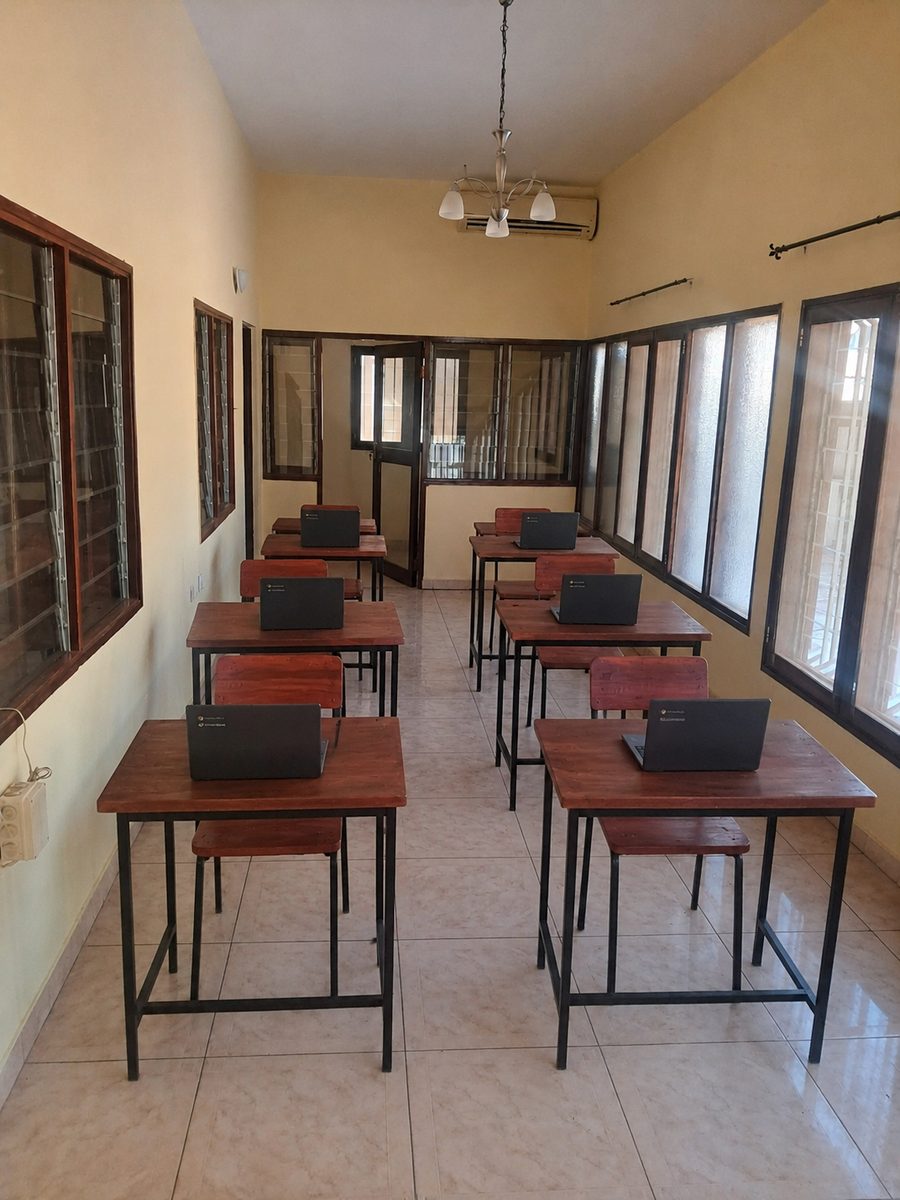 Classroom at the Starbridge academy in Tete with wooden desks and Chromebooks ready for students